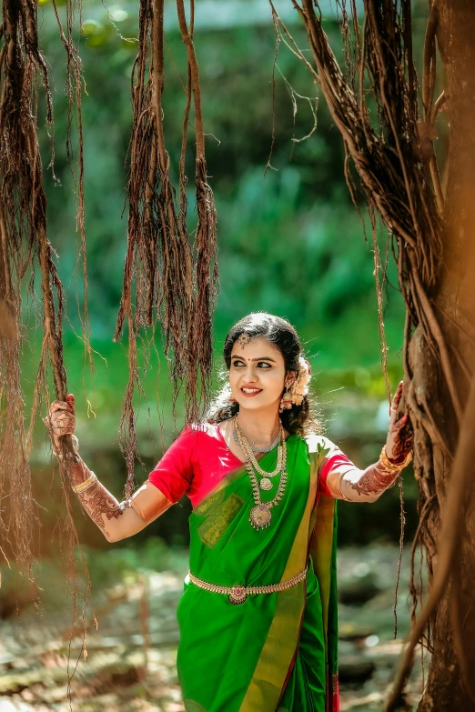 a beautiful woman in a green and yellow sari