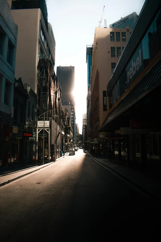 a view down an empty city street, in the sun
