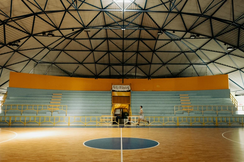 an empty basketball court with a goal in it