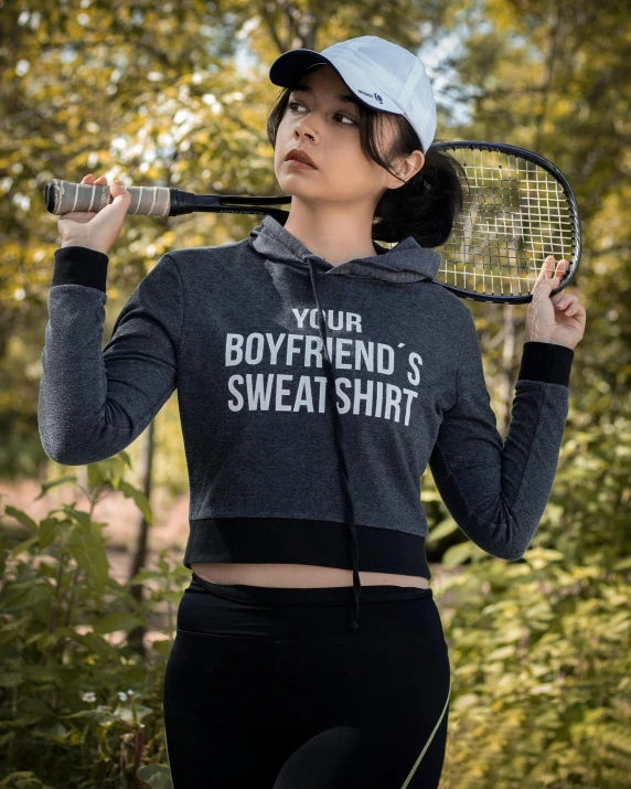 a woman holds tennis racket and prepares to hit a s