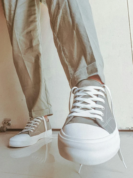 the legs and foot of a person with sneakers
