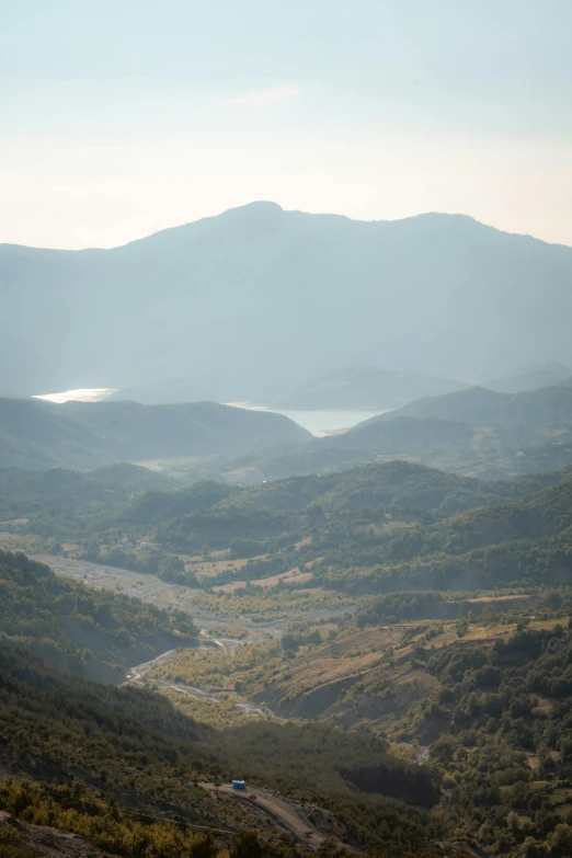 the view from a high hill looking down on the surrounding valley