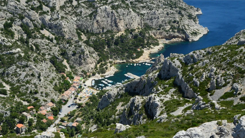 aerial view of small village with water and mountains