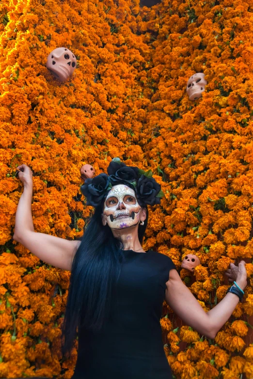 a woman wearing black clothing and some fake human face masks