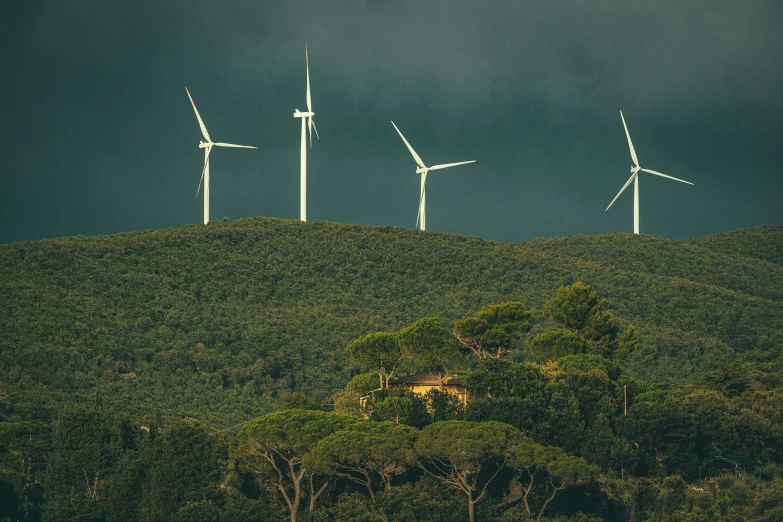 a couple of windmills sitting on top of a hill