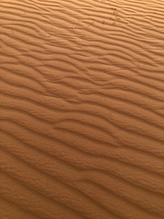a person walking on sand in the desert