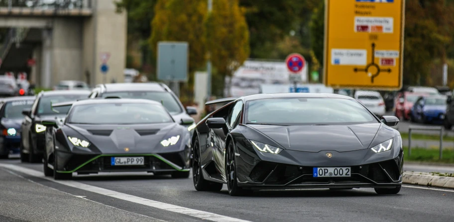 the black car is driving down the street