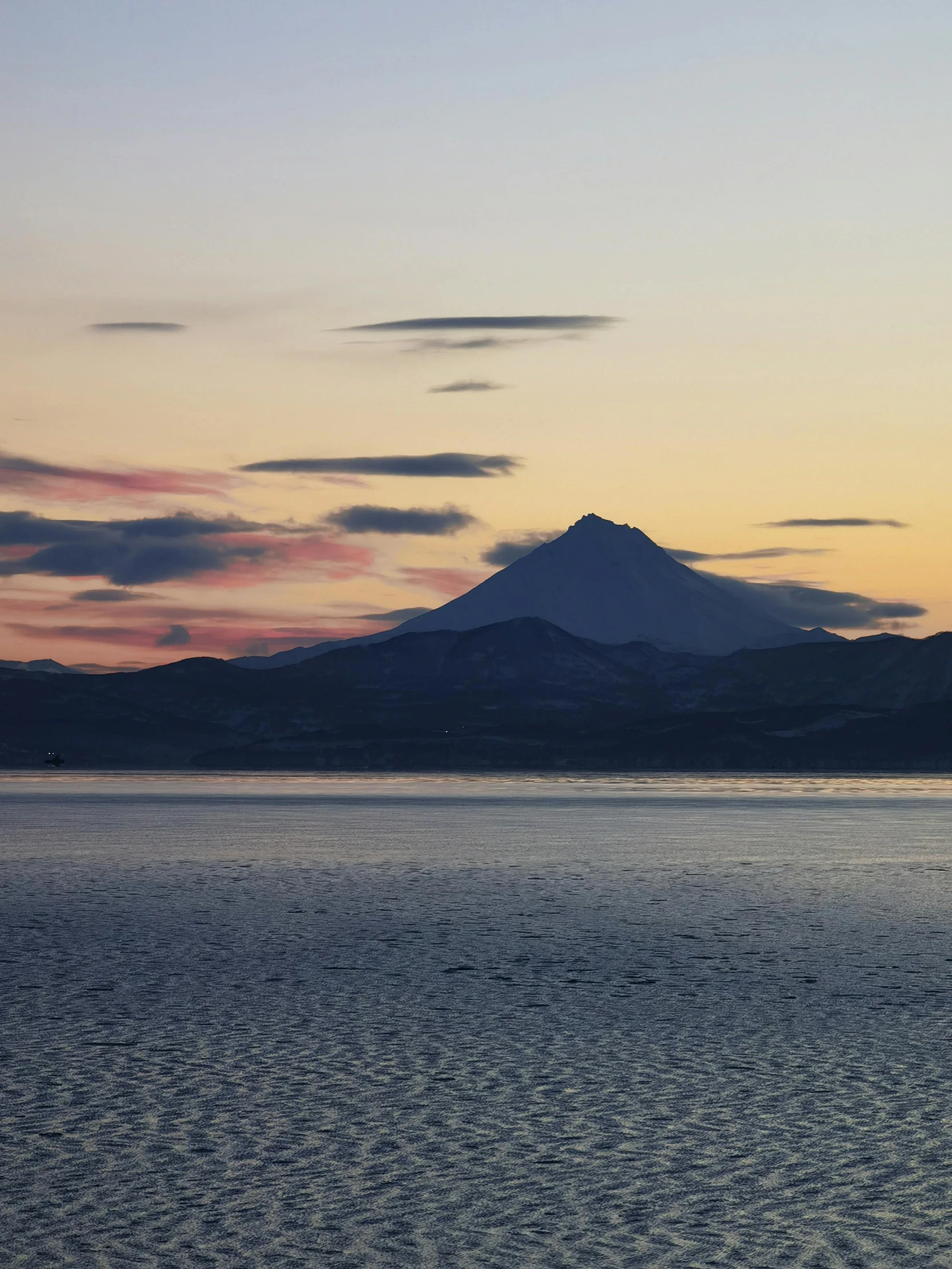 a distant mountain with a body of water