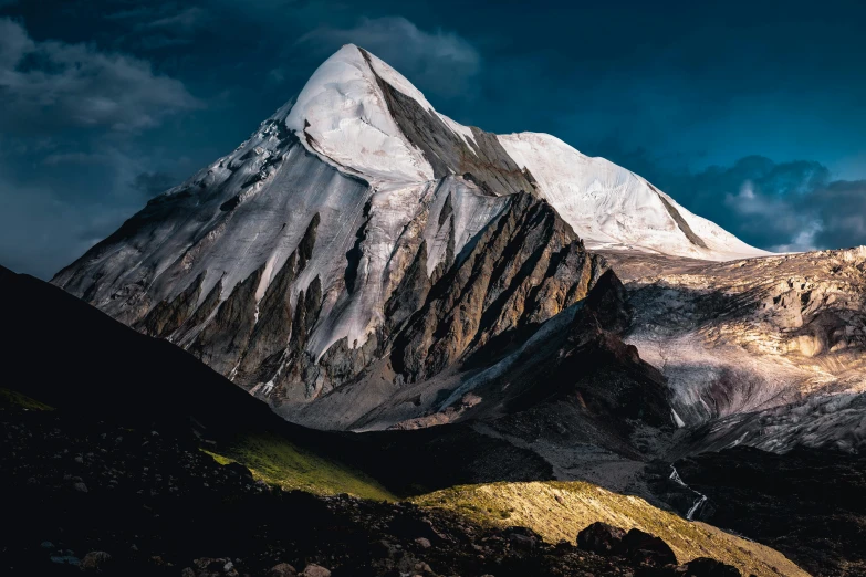 the top of a mountain under a cloudy sky