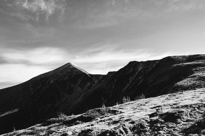 a black and white po of mountains and the sky