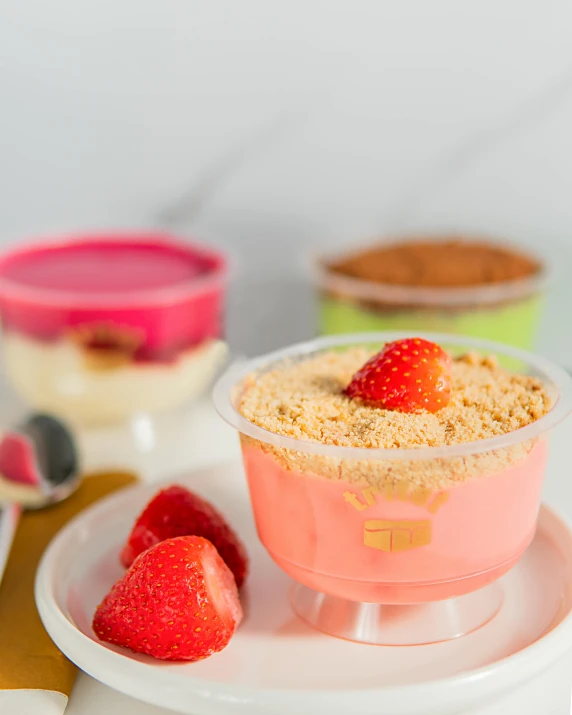 a dessert with fruits on a plate next to other desserts