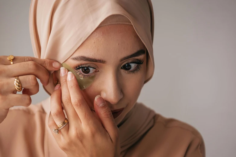 an attractive young woman holding up her gold ring