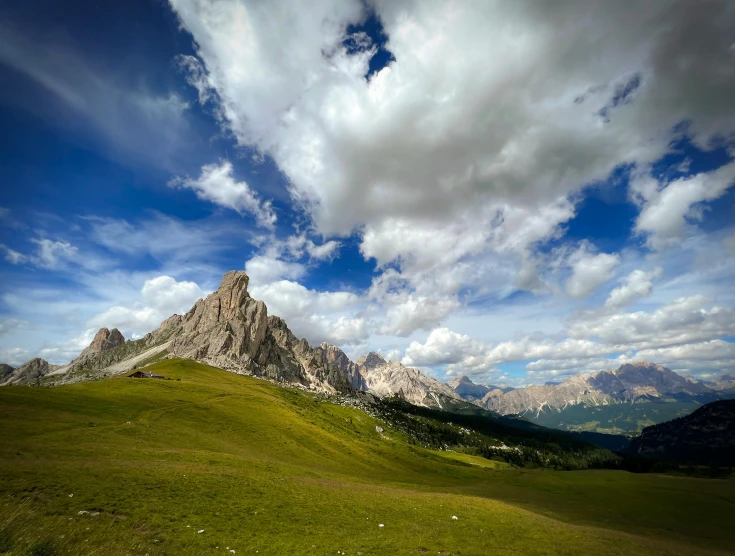 a beautiful landscape on a cloudy day with some mountains in the background