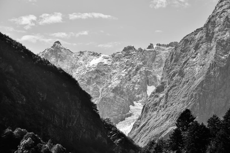 there are three snow covered mountains seen in this black and white po