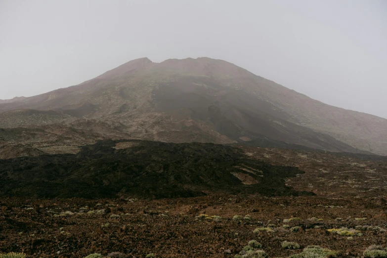 a barren landscape with a very tall peak