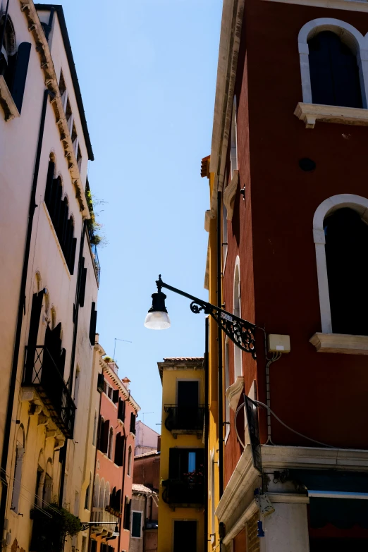 a street light on a red street in front of buildings