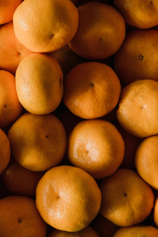 oranges are piled on top of each other