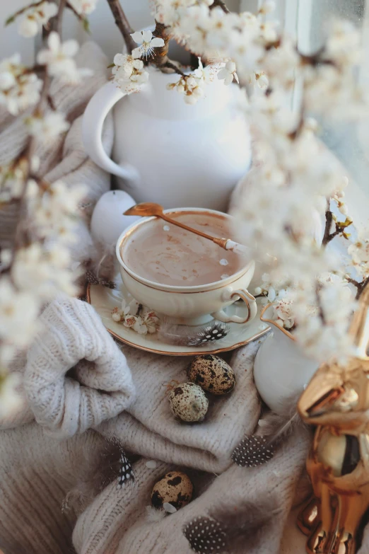 a tea pot filled with  chocolate surrounded by flowers