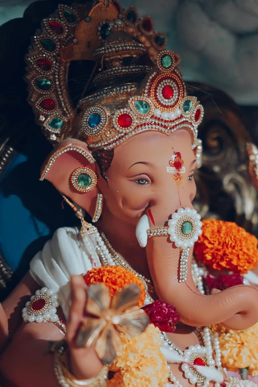 an elephant statue is shown adorned with flowers