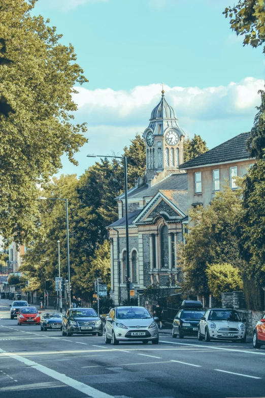 cars parked at the intersection and some buildings on the other side of a street