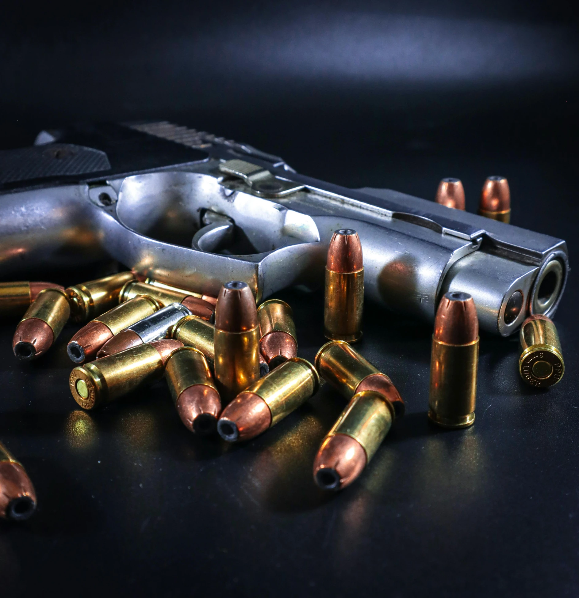 a group of bullet casings in front of a gun