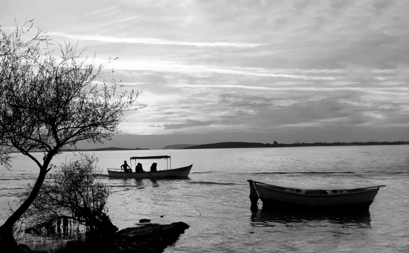 several boats on the water with dark clouds