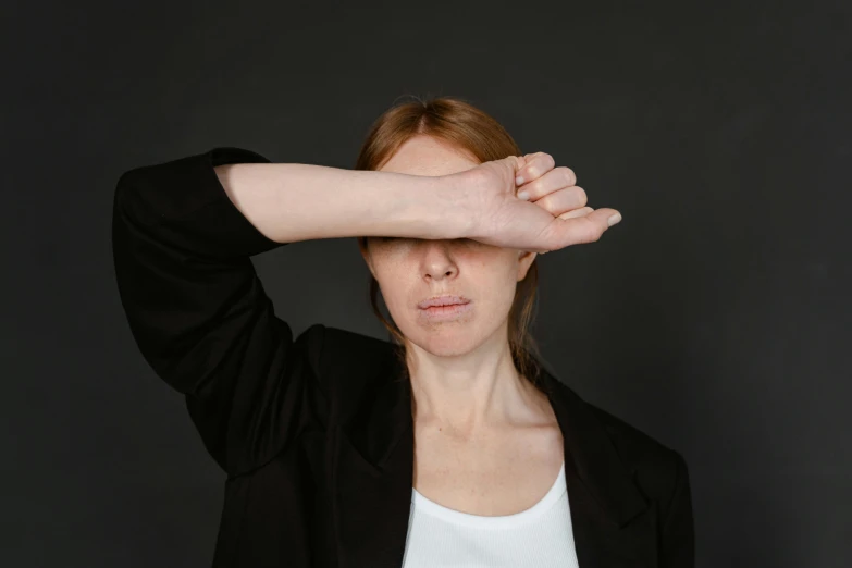 woman touching her hands on her forehead