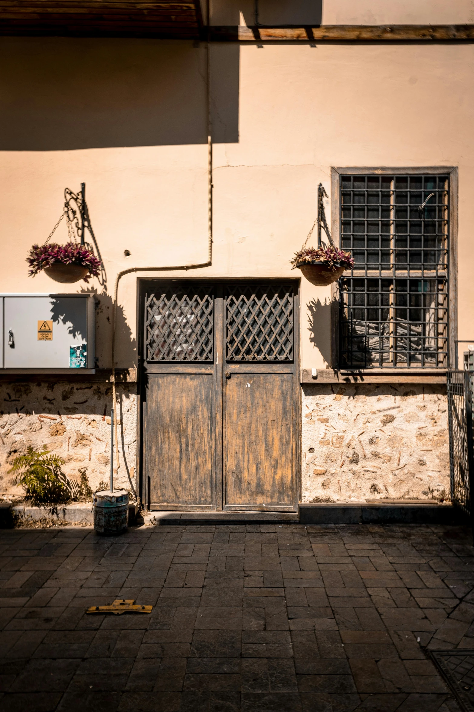 a stone and wood door on a side of a building