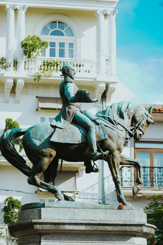 an image of statue with a building in the background