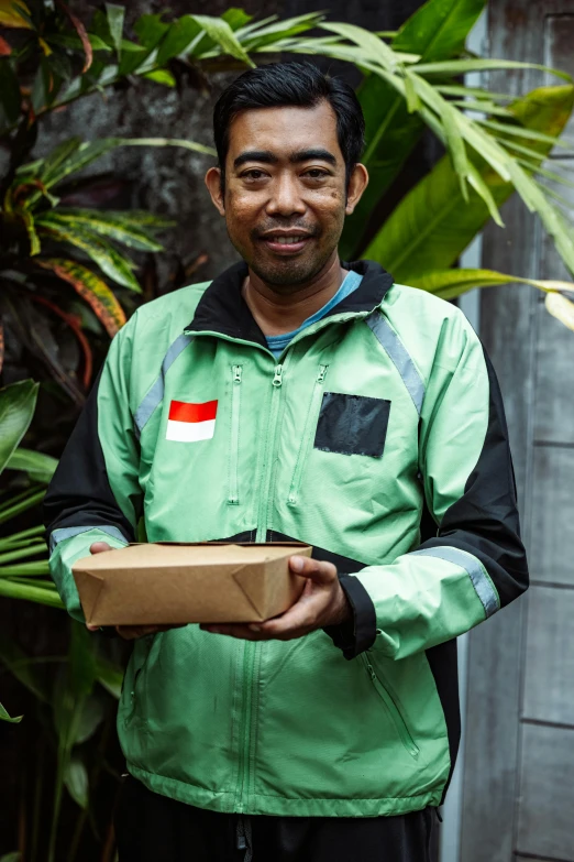 a man is holding an open box and smiling