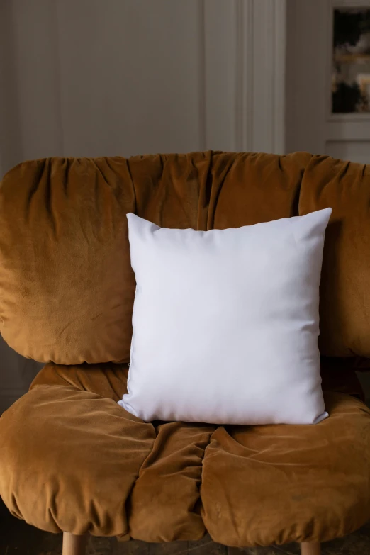 a chair with a white pillow sitting on top of it