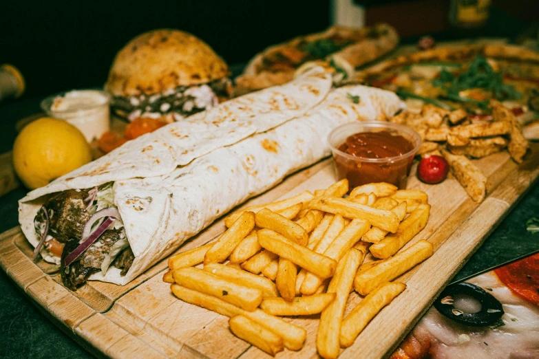 there is some food laid out on a wooden board