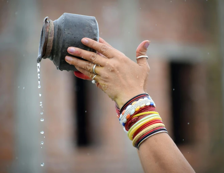 a hand holding an item that is dripping from it