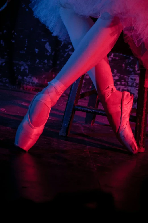 a dancer's shoes lit up by red light