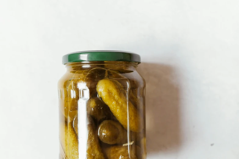 a jar filled with pickles is shown