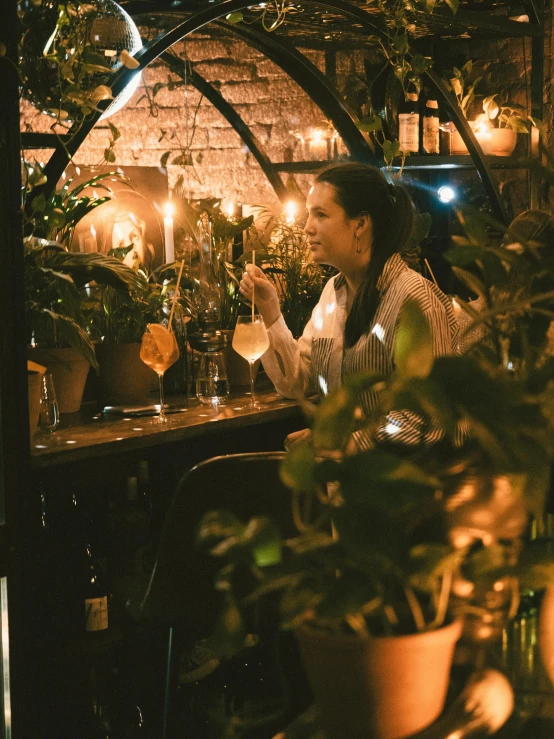 there is a woman sitting in a restaurant at the table