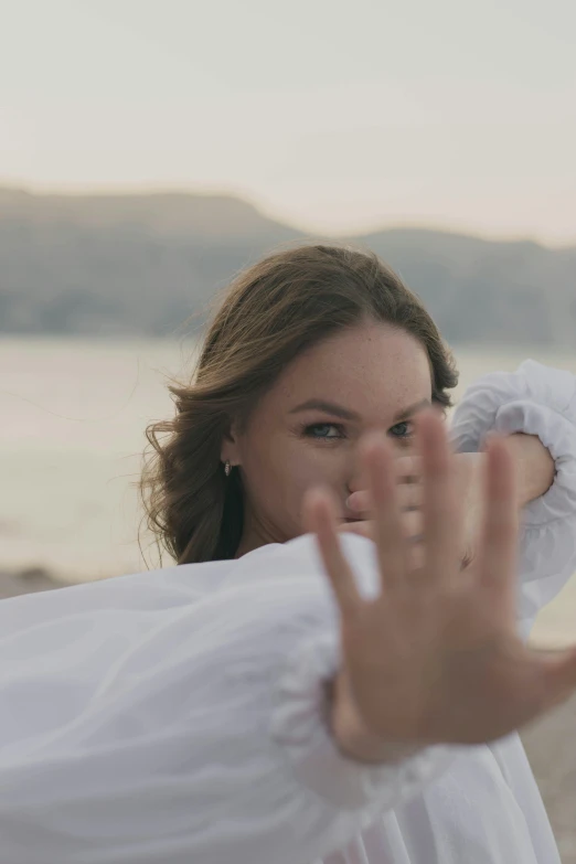 a woman making a gesture with her hands