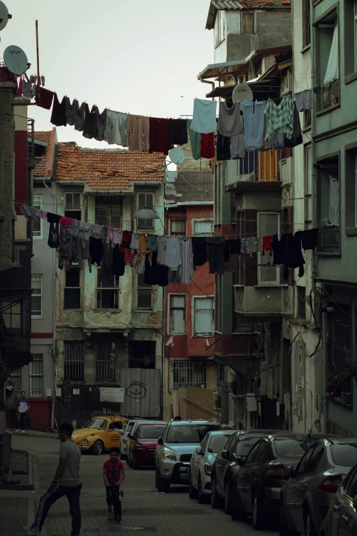 people and cars are parked in an urban area