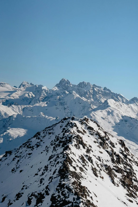 snow covered mountains covered in deep blue skies