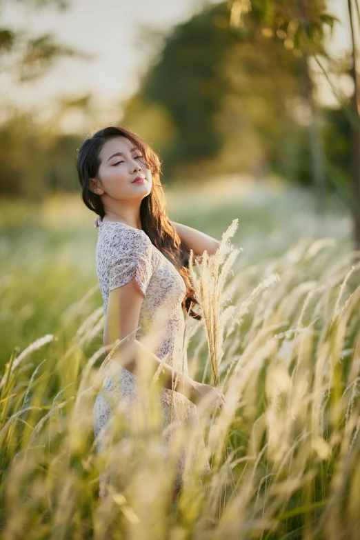 the woman in the grass looks up into the sky