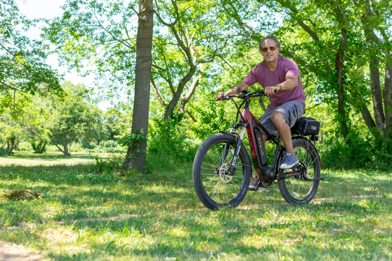 the man is riding his bike in the woods