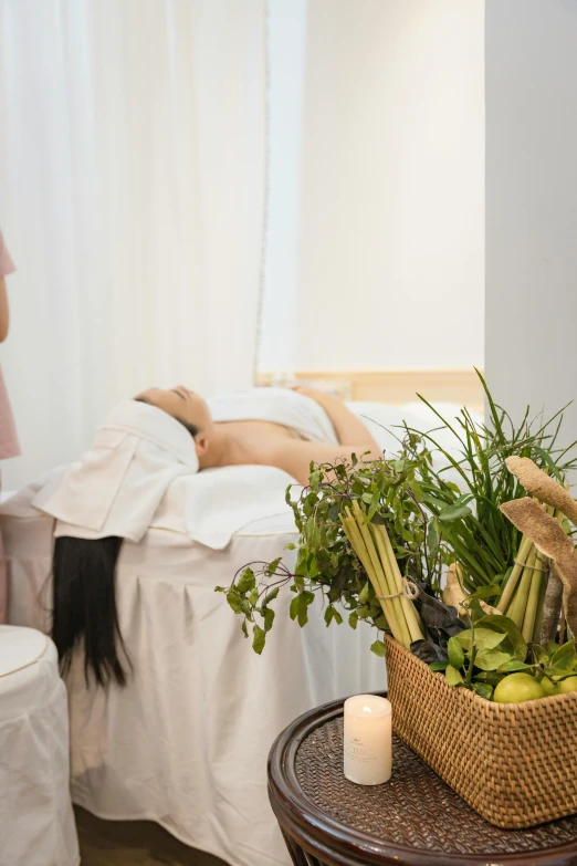 a woman is in a room with a bed and plants