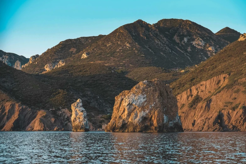 a boat floating along the side of a mountain side