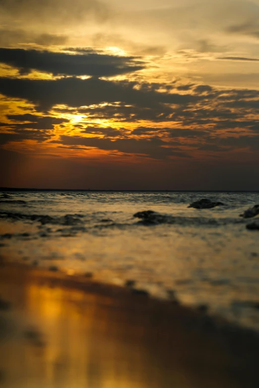 the ocean water is reflecting sunlight and clouds