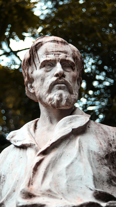 a statue of a man with a beard and coat