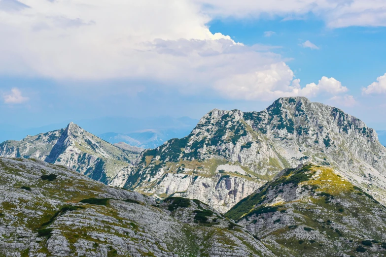 a mountain with lots of clouds in the sky