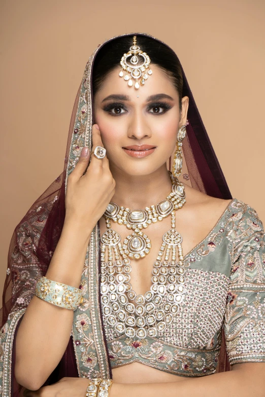 a woman wearing a wedding outfit and jewelry