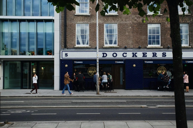 people walk past doctors in a city street