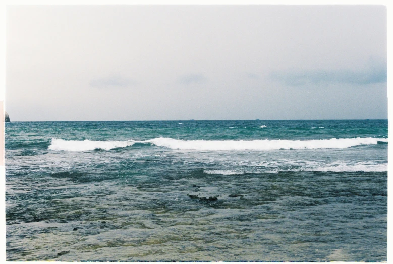 water with rocks under it as the tide rolls in