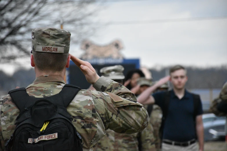 men in uniform are on the street and talking on their cell phones